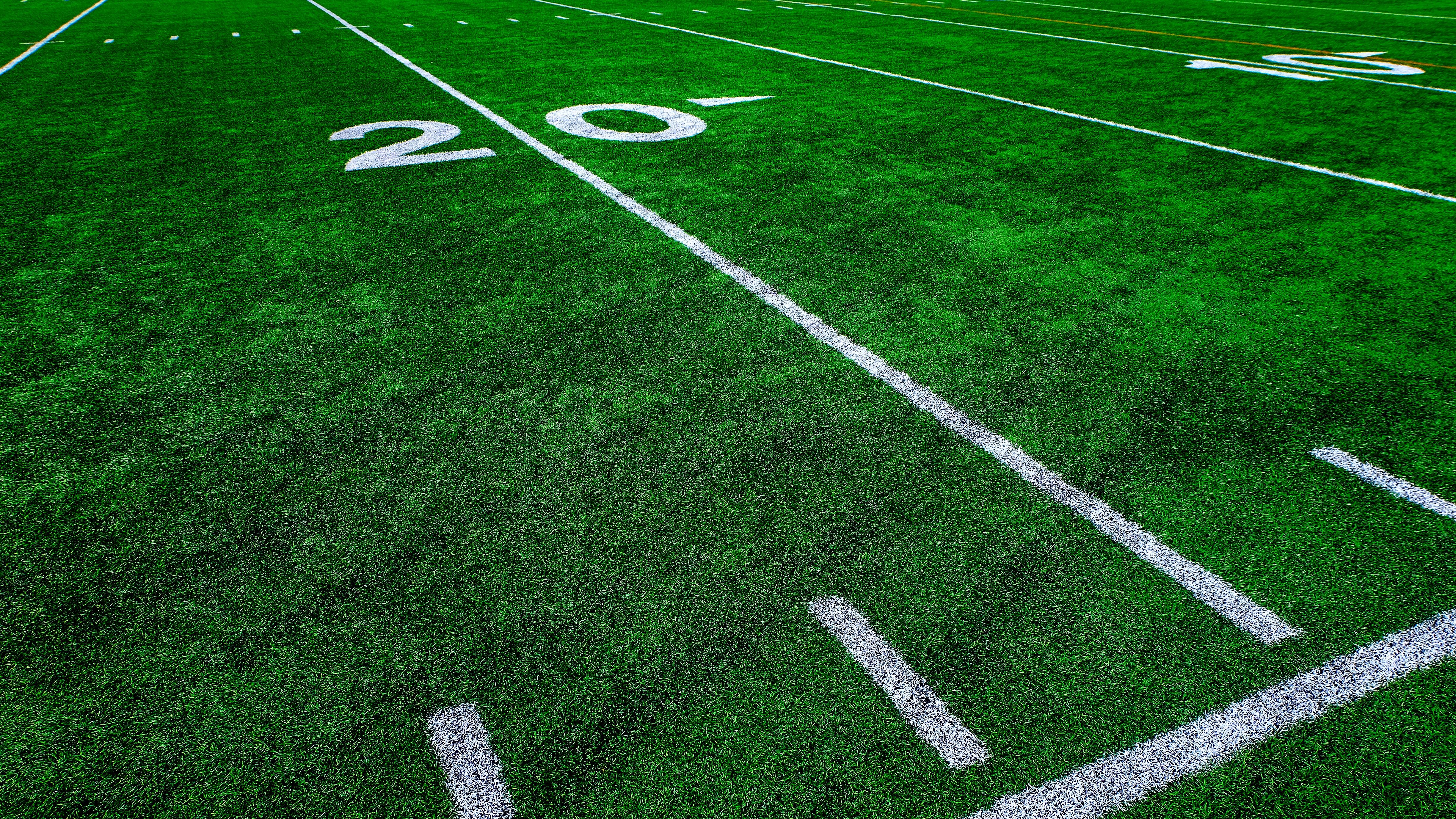 Football field green grass white yard markers to touchdown competition game