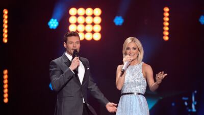 HOLLYWOOD, CALIFORNIA - APRIL 07: Host Ryan Seacrest (L) and recording artist Carrie Underwood speak onstage during FOX's "American Idol" Finale For The Farewell Season at Dolby Theatre on April 7, 2016 in Hollywood, California. at Dolby Theatre on April 7, 2016 in Hollywood, California. (Photo by Kevork Djansezian/Getty Images)